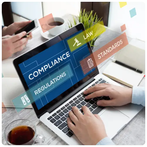 Person typing on a laptop displaying “Compliance and Regulations” — representing Salusphere Global’s focus on workplace safety and regulatory standards.