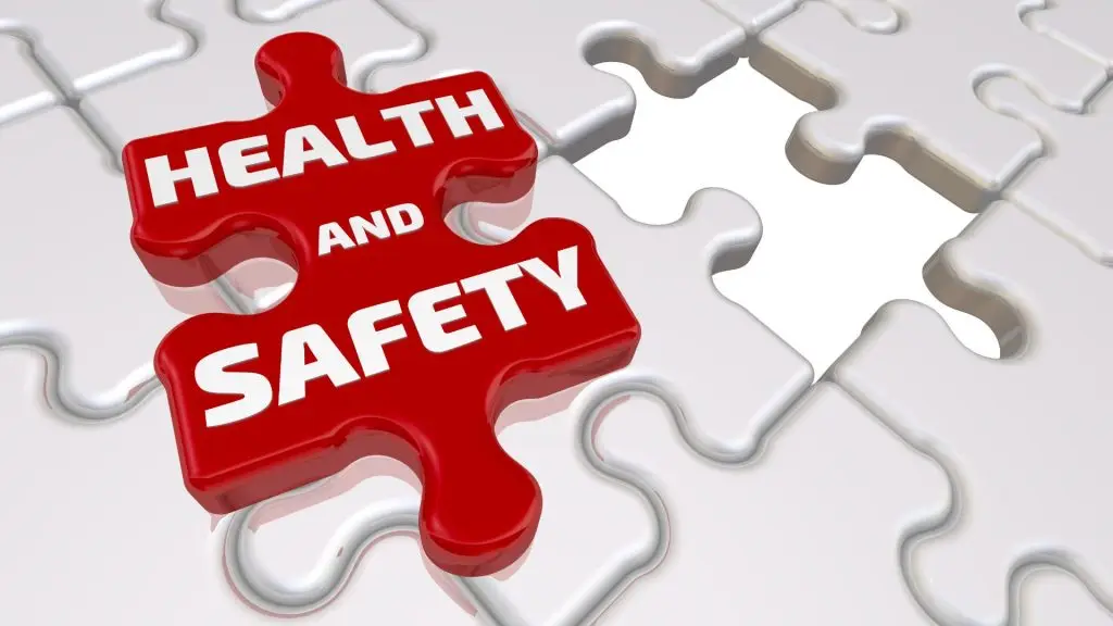 White puzzle pieces with one red piece out of place labeled “Health and Safety” — representing critical focus on safety compliance.
