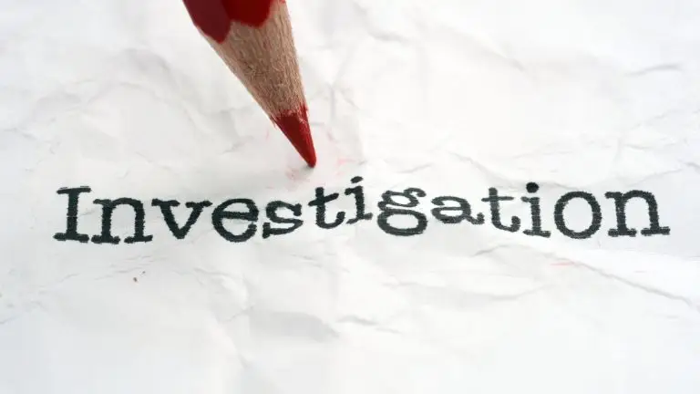 Pencil resting on paper with “Investigation” written — representing accident investigation processes