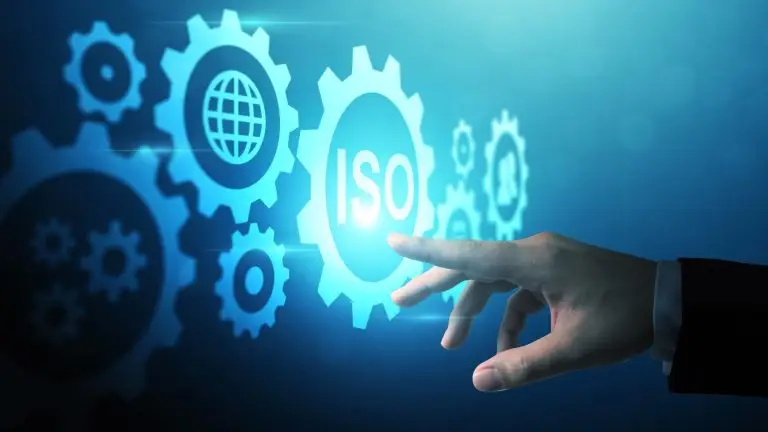 Digital cogs with “ISO” and a hand touching the interface — representing ISO compliance and management services.