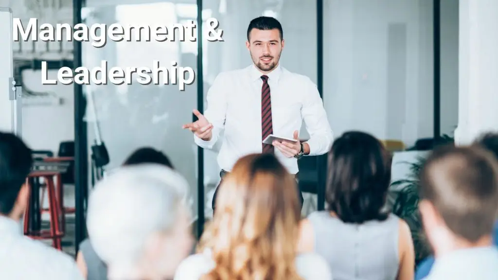 Lecturer addressing a classroom of professionals — depicting management and leadership training courses.