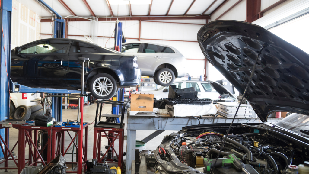 Garage workshop with vehicle lift and forecourt safety guidance